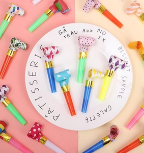 Colorful party blowouts whistle set on white plate for birthday celebration party