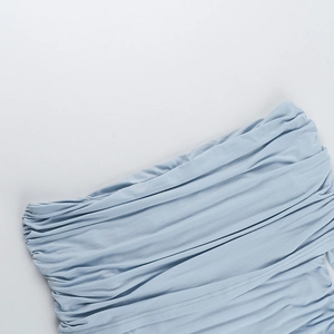 Detail of light blue off-shoulder top showing pleated texture and knit fabric quality