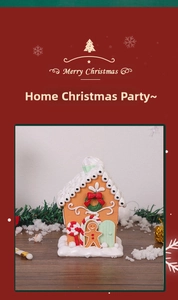 Detailed view of festive gingerbread house ornament with snowy roof and candy cane accents