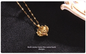 Detailed close-up of a gold heart pendant necklace with intricate baroque hollow pattern