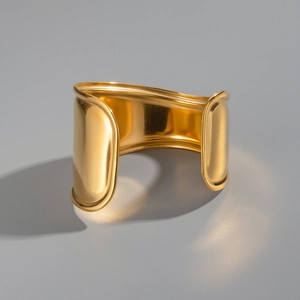 Detailed view of wide wave open cuff bracelet in 18K gold plated polished stainless steel