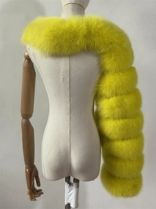 Detail of faux fox fur shawl in neon yellow with high volume and layered texture design