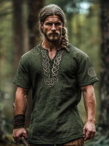 Detail of Celtic knot embroidery on a green Viking shirt with lace-up V-neckline