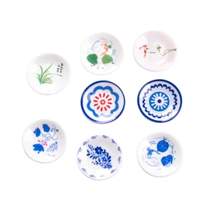 Nine miniature ceramic plates with blue and white porcelain floral and koi fish patterns
