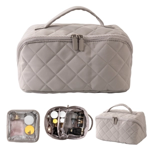 Detail of light gray quilted cosmetic bag showing spacious interior with multi-layered storage