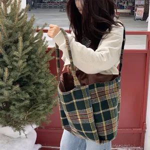 Détail de la texture épaisse du tissu écossais vintage sur un grand sac de shopping