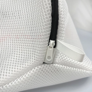 Close-up of fine mesh laundry bag with durable black zipper and protective lanyard