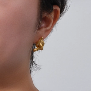 Modern gold-tone knotted button stud earrings made of brushed stainless steel for women
