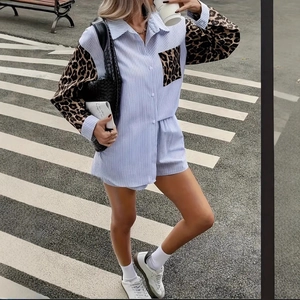 Detail of striped shirt and shorts set with leopard print patches in street setting