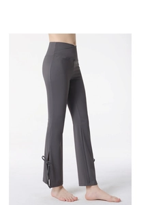 Detail of high waist flared yoga pants with crossover waist and side bow ties