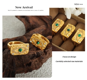 Detail view of retro gold ring with green gemstone and zircon in elegant jewelry box
