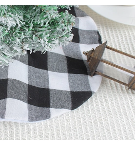 Detail view of round black and white buffalo plaid Christmas tree skirt decoration