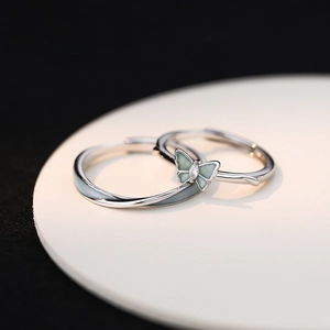 Luminous S925 sterling silver butterfly couple rings on a minimalist white display card
