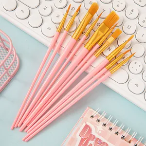 Detail of 10-piece pink nylon hair paintbrush set on a desk with creative accessories
