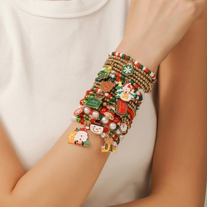 Detail of Christmas beaded bracelet set with Santa, reindeer, and festive charms on wrist