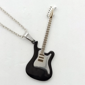 Close-up of black and silver guitar pendant necklace with detailed metal craftsmanship