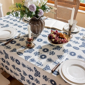Close-up of linen tablecloth featuring vintage blue butterfly and floral prints