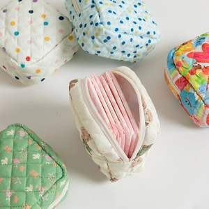 Internal view of quilted floral sanitary bag showing spacious storage for pads