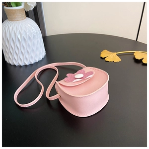 Detailed view of pink floral kid's crossbody bag with glitter petals and faux leather texture