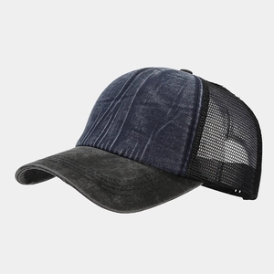 Detail of washed denim trucker hat featuring mesh back and adjustable snap closure