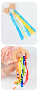 Detail of baby sensory ring toy with colorful ribbons and natural wooden cloud handle