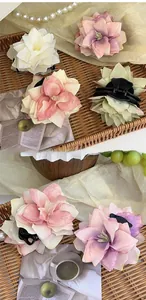 Macro detail of French style large silk flower hair claw with realistic multi-layer petals