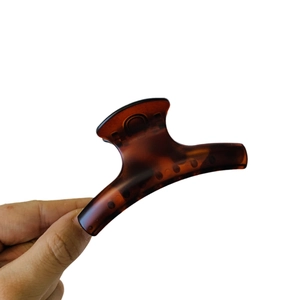 Elegant amber tortoiseshell hair claw clip in a classic French style for women hair styling