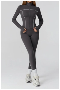 Detail of dark grey yoga set featuring contrasting white stitching and slim fit design