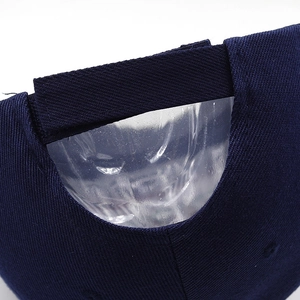 Close-up of adjustable velcro strap and cotton twill texture on a navy baseball cap
