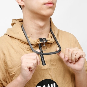 Detail of a men's black snake bone chain necklace worn by a model on white background