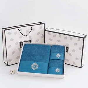 Blue cotton towel gift set featuring embroidered crown detailing in premium gift packaging