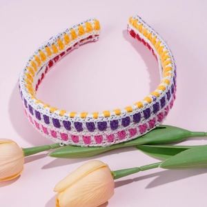 Detailed macro view of multi-color crochet knitted headband with floral hollow pattern