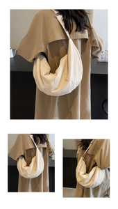 Close-up detail of beige nylon dumpling crossbody bag showing large storage capacity