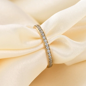 2mm gold-tone stainless steel eternity ring with pavé-set crystals on beige silk fabric