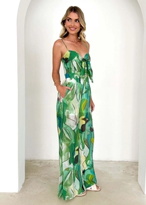 Detail of tropical leaf print jumpsuit with v-neckline and decorative bow tie front