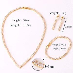 Detailed view of V-shaped gold jewelry set with necklace, earrings and bracelet specs