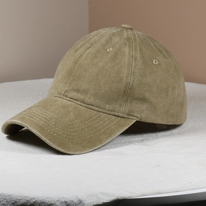 Detailed texture of khaki washed cotton baseball cap with vintage distressed fabric finish