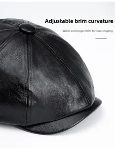Detail of black PU leather baker boy hat showing textured grain and foldable brim