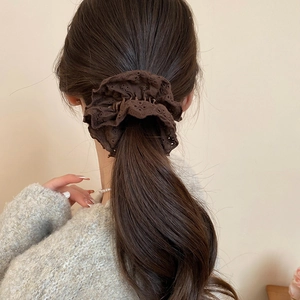 Detailed texture of dark brown double-layer hollow lace scrunchie on ponytail
