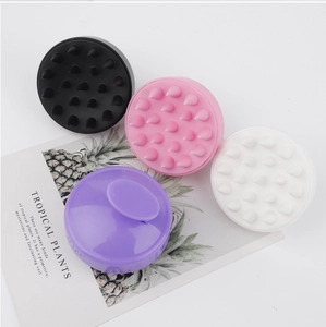 Flat lay of colorful 19-tooth silicone scalp massagers in black, pink, white and purple