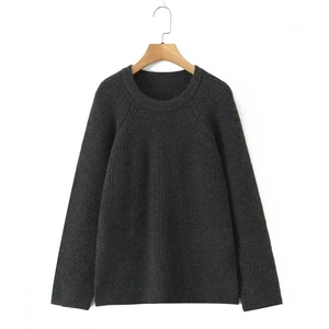 Detail of dark grey knit sweater showing thick ribbed texture and premium fiber quality