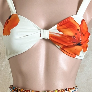 Detail of floral bikini top with orange blossoms and colorful beaded waist chain