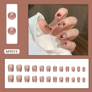 Pink cat eye press-on nails with red heart patterns in a short ballet shape