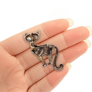 Vintage gold cat brooch with green crystal inlay showing the back pin lock mechanism