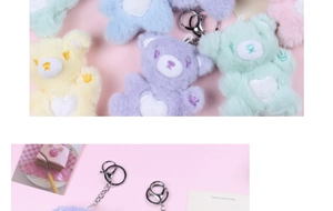 Detail of colorful plush teddy bear keychains showing soft texture and metal clips