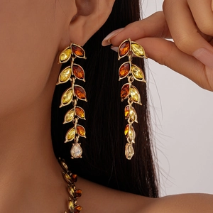 Detail of vintage gold necklace and earring set with amber marquise crystals