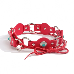 Detail of red leather belt with turquoise stone accents and silver metal ring links