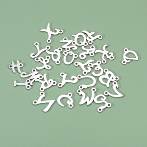 Polished stainless steel cursive alphabet pendants for jewelry making on light green surface