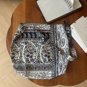 Bohemian paisley printed canvas bag detail on a wooden table for lifestyle display