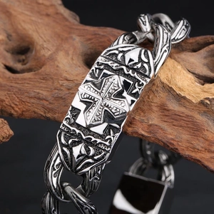 Vintage stainless steel cross bracelet with embossed details on a chunky silver chain link